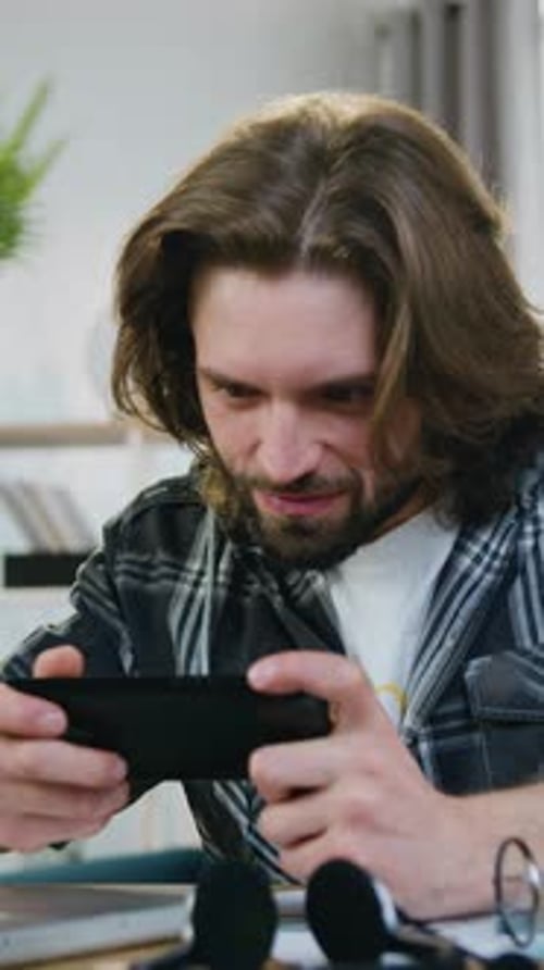 Excited Man Playing Mobile Game and Celebrating Victory