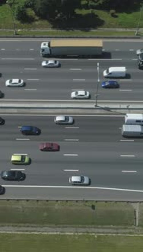 Cars on Highway in City in Sunny Summer Day Aerial View Vertical Video