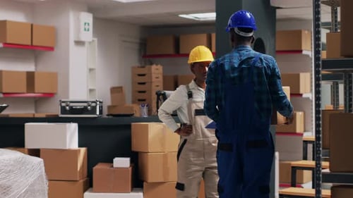 Workers Discussing Project in Warehouse
