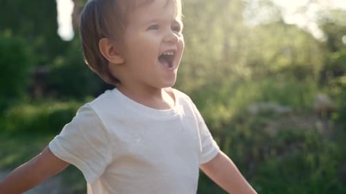 Happy Child Laughing Outdoors in Nature