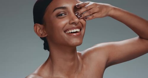 Skincare, face touch and beauty of woman in studio isolated on a gray background