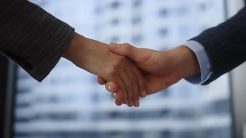 Business people handshake closeup at successful deal in office meeting