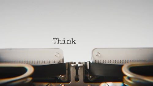 Old mechanical typewriter typing Think Positive in a close-up view.