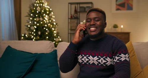 Cheerful Man Talking on Phone at Christmas