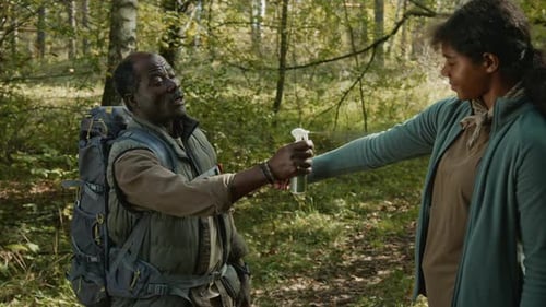 Caring Dad Applying Insect Repellent on Daughters Zip-up Sweatshirt in Woods