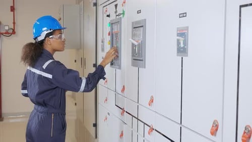 Woman Engineer Operating Control Panel in Workplace