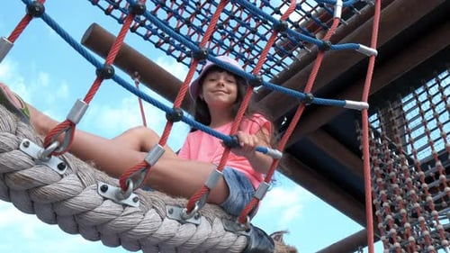 Child Plays on Rope Structure on Sunny Day