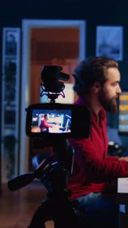 Man with long hair sitting in front of computer