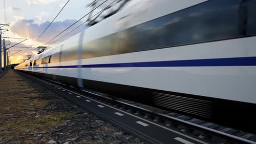 High Speed Train Speeds Through Countryside at Sunset