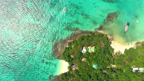 Aerial view of iconic tropical turquoise water Pileh Lagoon surrounded by limestone cliffs, Phi Phi