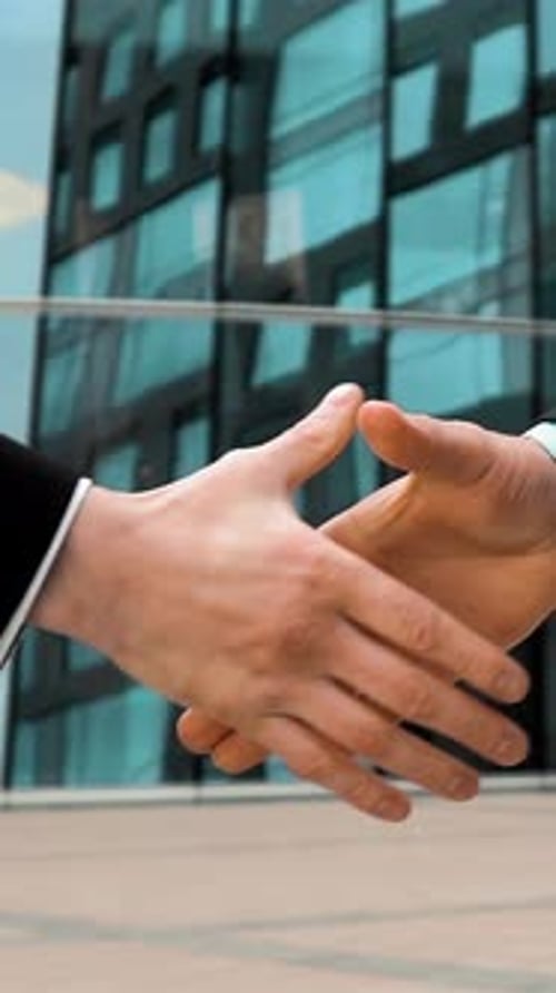 Vertical of Two Business Partner Shake Hands