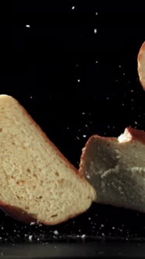 Pieces of Bread Falling on a Black Background Filmed on a Highspeed Camera at 1000 Fps