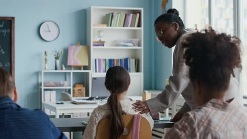 Children learning in classroom with teacher instruction