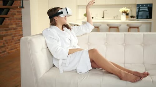 Woman Experiencing Virtual Reality Headset on Sofa