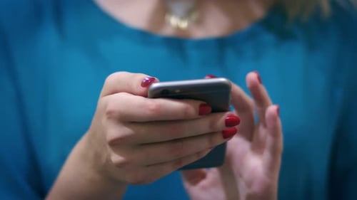 Woman Hand Typing Mobile Message on Screen Smartphone. Close Up Female Hands