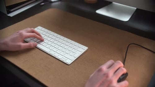 Man using his mouse and keyboard in his office.