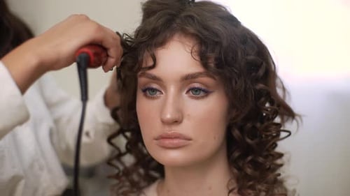 Closeup Front View of Unrecognizable Makeup Artist Applying Toner on Face of Beautiful Model