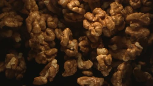 Close Up of Shelled Walnuts on Dark Background