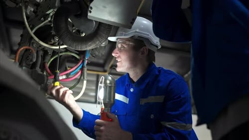Both of engineers working together in a robotic arm factory,