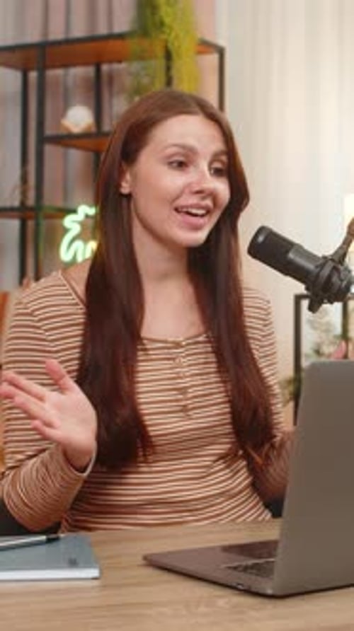 Young Woman Records Vlog on Studio Mic Greets Audience Shares Useful Info and Invites to Subscribe