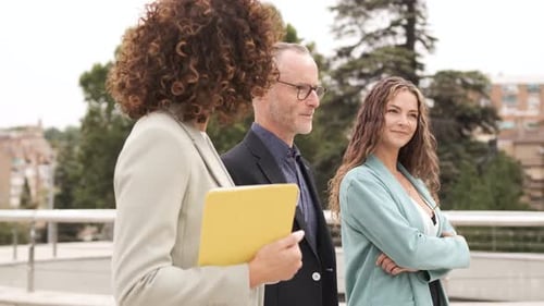Happy Business People Discussing While Walking in City
