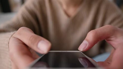 Close Up of Mobile Phone Use Indoors