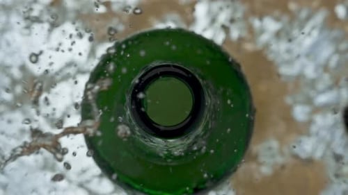 Golden Ale Glass Overflows Closeup. Cold Light Craft Spilling On Surface Super Slow Motion. Hop E...