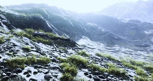 Mountain Landscape Under Bright Light with Rocky Terrain and Greenery