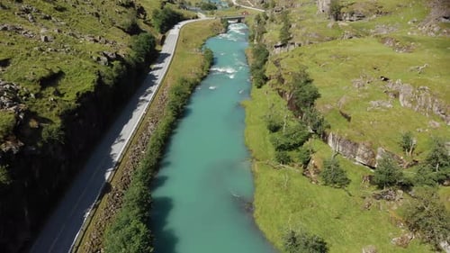 A road that was shot from above in Norway.
The road is near the city Skei.
Drone flies backwards and