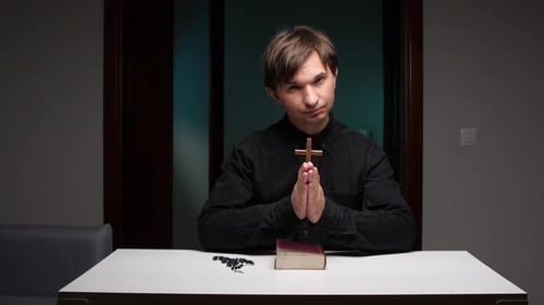 Man with Praying Hands and a Bible