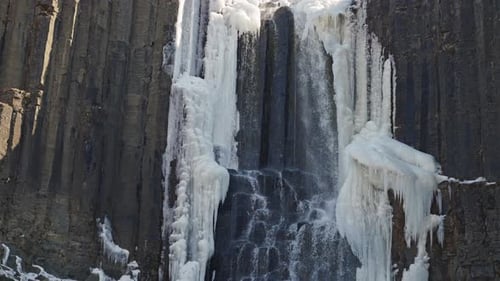 Water Cascading Down Basalt Cliffs Of Studlagil Canyon