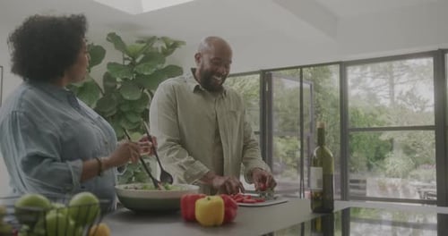 Couple Prepares Salad Together in Modern Kitchen