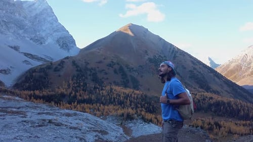 Hiker pointing up in mountains Kananaskis Alberta Canada