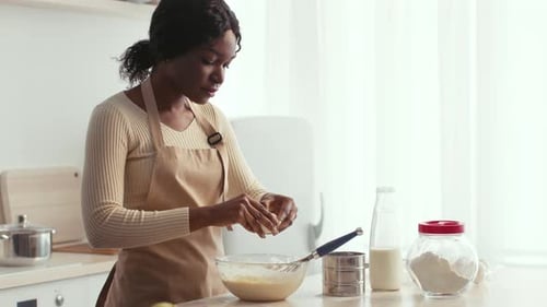 Mother Baking Pastries in a Cozy Kitchen