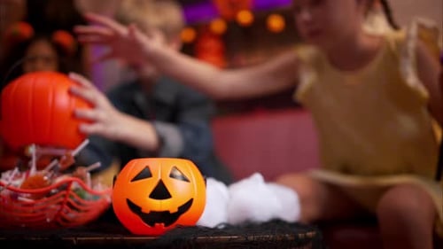 Children Celebrating Halloween with Candy and Decorations