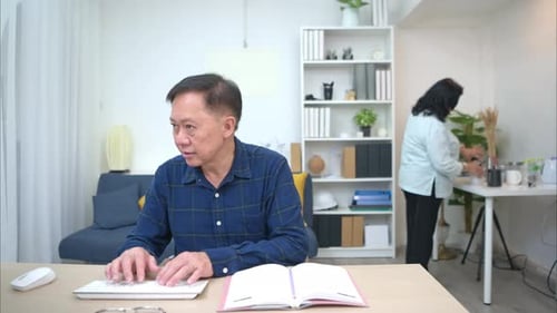 Man Typing, Woman Brings Him Coffee in Home
