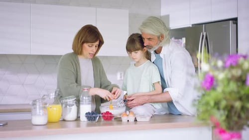 Beautiful Family at Home Preparing a Breakfast Together