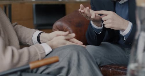 Two People Talking with Hands Clasping