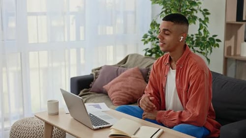 Young Adult Working on Laptop at Home