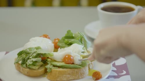 Cutting into Poached Eggs and Avocado Toast