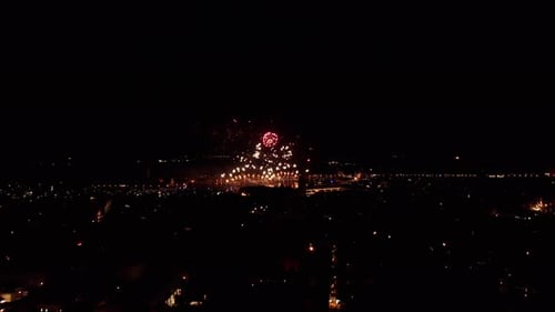 Fireworks illuminate the night sky above Venice during the Carnival celebration, wide shot
