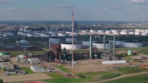 Expansive Aerial View of Industrial Refinery with Tanks and Equipment