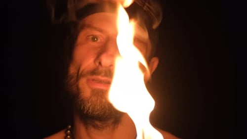 Man Lit by Flame in the Dark