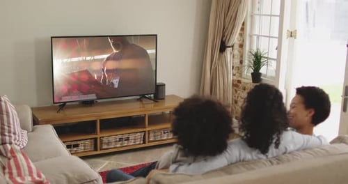 Family Watching Television Together on Couch