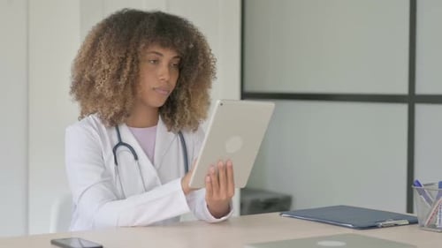 Doctor uses tablet for telehealth in office