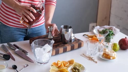 Person Making Cocktail with Ingredients at Home