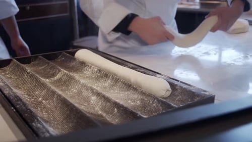 Baker Shaping Dough in a Professional Kitchen