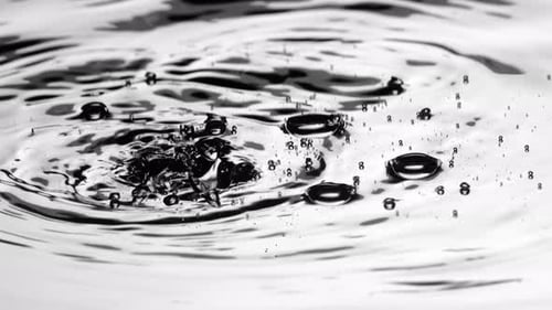 Water Droplets Create Ripples on Liquid Surface