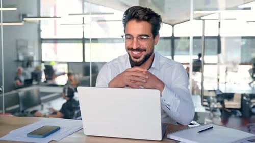 Happy Young Latin Business Man Working in Office Having Hybrid Meeting