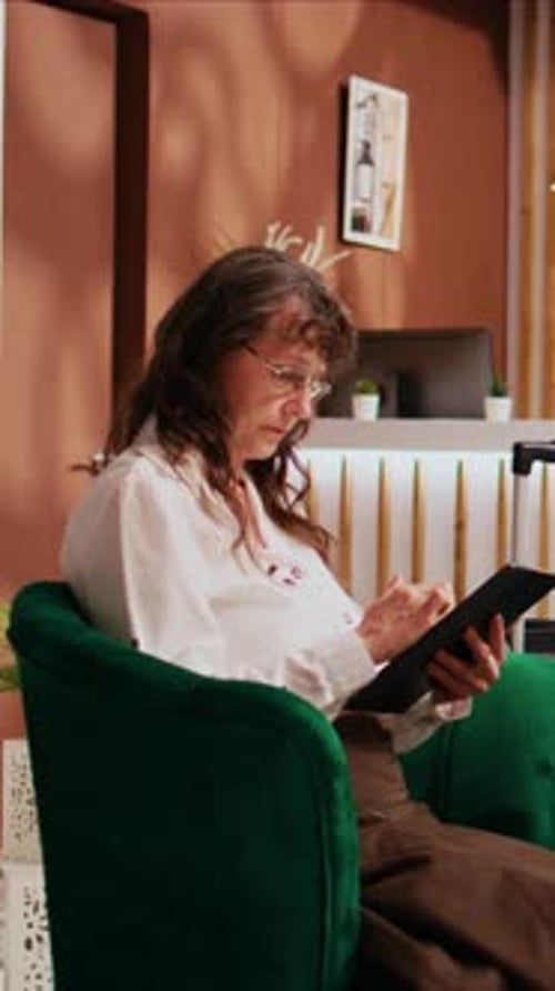 Vertical Video Hotel Guest Relaxing in Lounge Area
